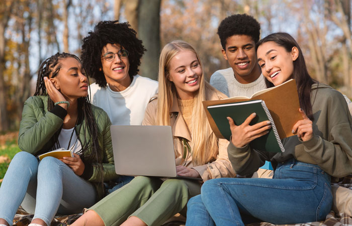 Diverse group of students studying together outside